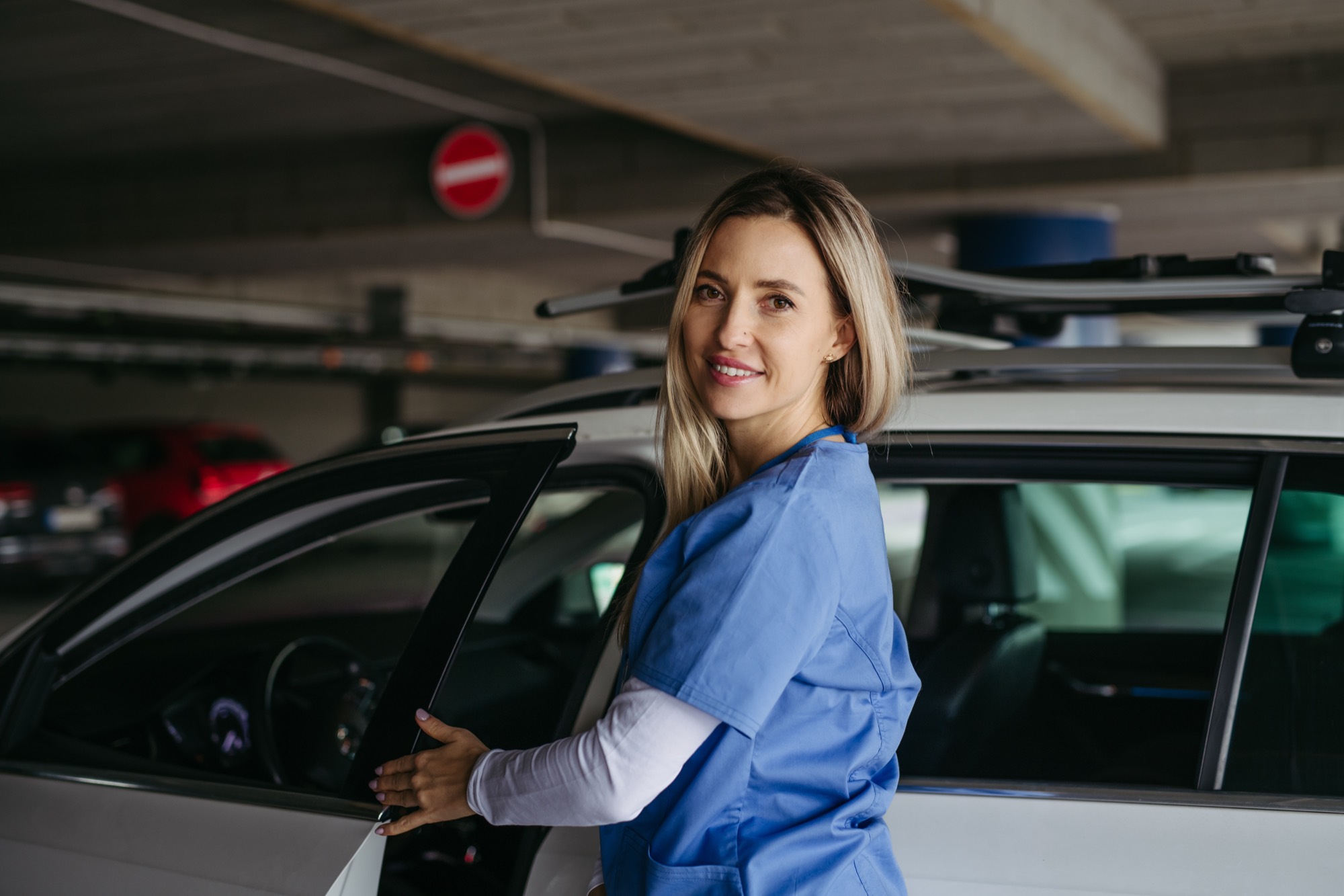 A Thrive Living nurse opening a car door, ready to drive a client to a follow-up appointment